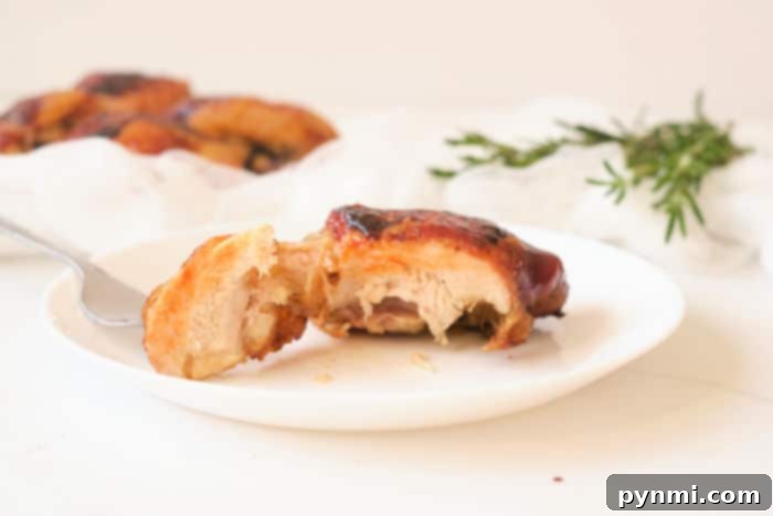 Mastering Frozen Chicken Thighs in Your Air Fryer 9 Close-up of a perfectly cooked chicken thigh on a serving board, garnished with fresh herbs, highlighting its crispy skin and juicy interior.