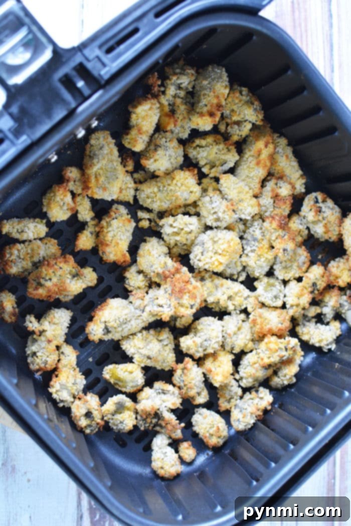 Crispy Air Fryer Oysters 6 Oysters perfectly arranged in an air fryer basket, ready for cooking.