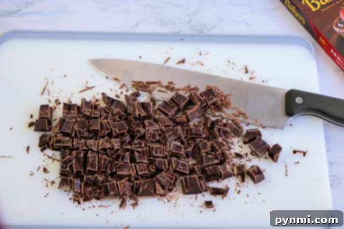 A close-up of dark chocolate chips melted into a warm cookie, showing rich texture.