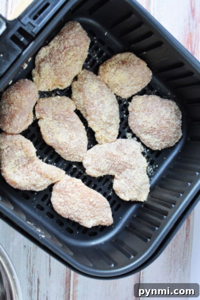 Crispy Air-Fried Boneless Chicken Bites 6 A close-up of air fryer boneless chicken wings seasoned and ready to be cooked, emphasizing their appeal as an easy, healthy meal.