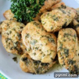 Crispy Air-Fried Boneless Chicken Bites 7 A plate of herb-crusted, air fryer boneless wings garnished with fresh parsley.