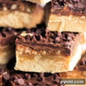 Stack of decadent chocolate chip caramel bars with a thick cookie base and rich chocolate topping, reminiscent of classic pecan shortbread bars.