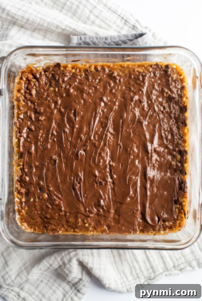 Buttery Pecan Shortbread Squares 7 Stacked pecan chocolate bars, showcasing the rich layers of shortbread, caramel, pecans, and melted chocolate, a truly irresistible treat.