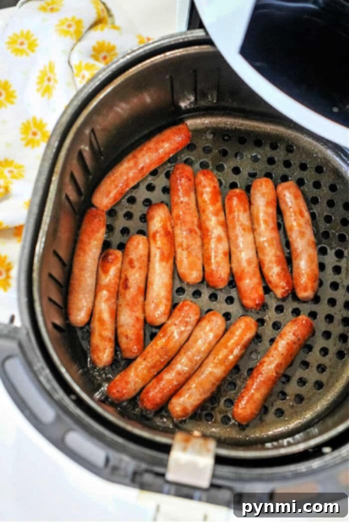 Air Fryer Sausage Perfection 8 A close-up of Jimmy Dean sausage links cooking in an air fryer basket, with visible browning.