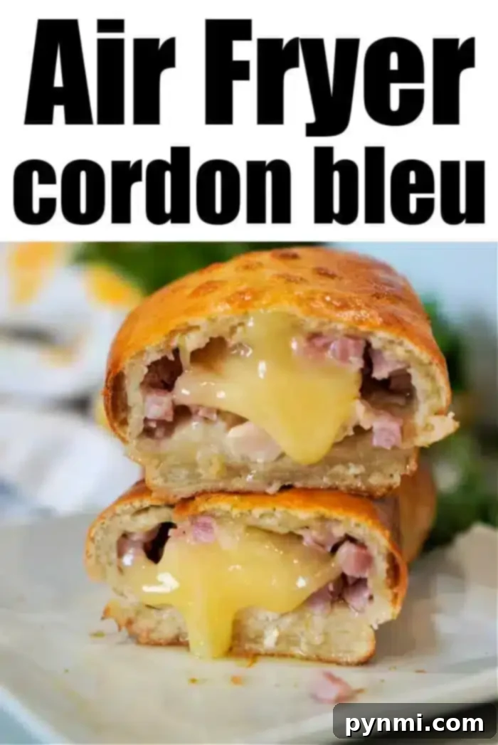 A close-up of an air fryer chicken cordon bleu, sliced in half to reveal melted cheese and pieces of ham nestled within a golden-brown crust. The text above reads "Air Fryer Chicken Cordon Bleu." The dish is elegantly presented on a white plate.