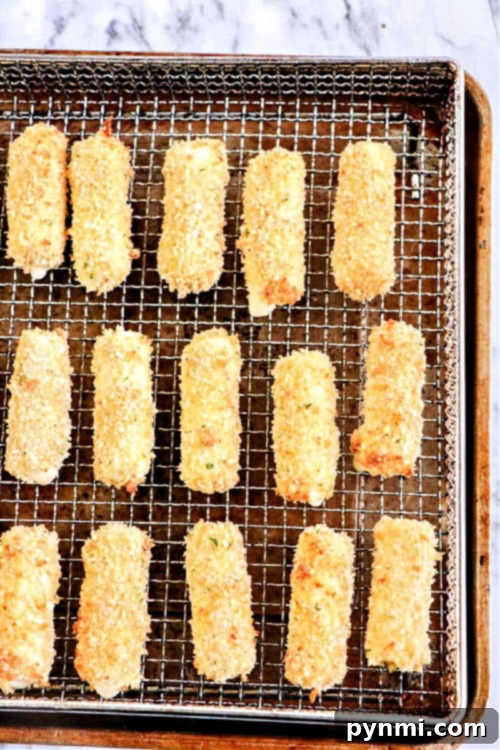 Crispy Homemade Air Fryer Mozzarella Sticks 2 Delicious homemade mozzarella sticks air fried to golden perfection, ready to be enjoyed.