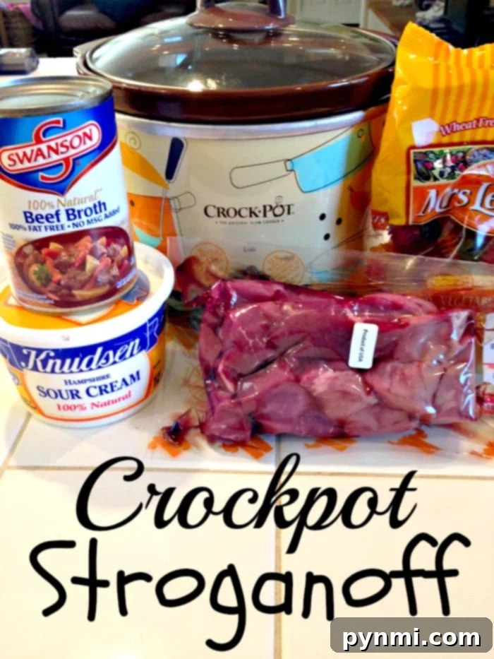Crockpot Beef Stroganoff that only requires 5 ingredients and cooks all day in the crockpot. The best way to make tender beef with a creamy sauce. #crockpot #slowcooker #beefstroganoff #beef #stew The Absolute Best Crockpot Beef Stroganoff Recipe – a close-up of tender beef and creamy sauce.
