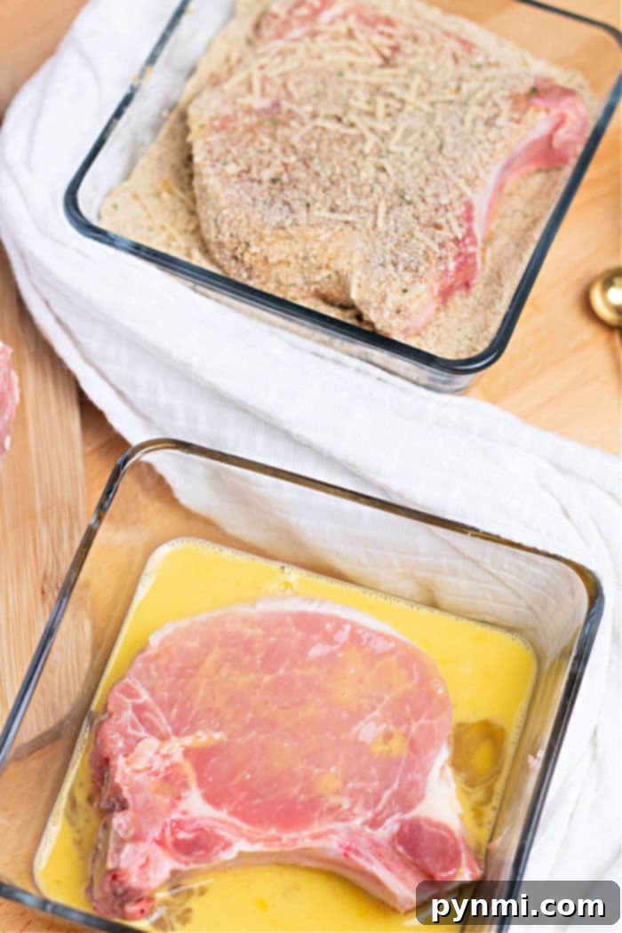 Pork chops being breaded for the air fryer.