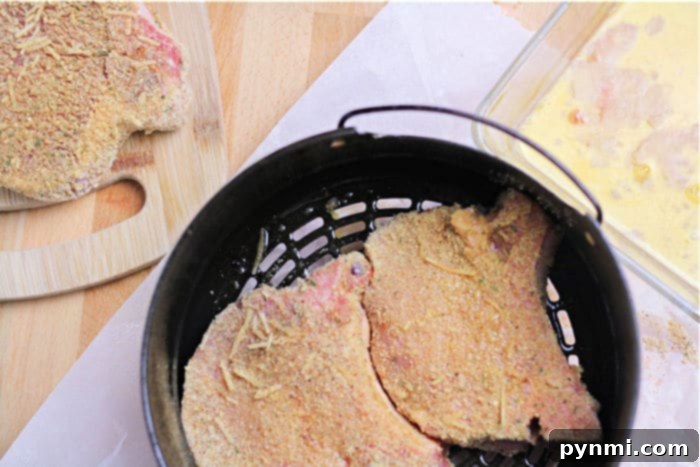 Close-up of a breaded pork chop ready for air frying.
