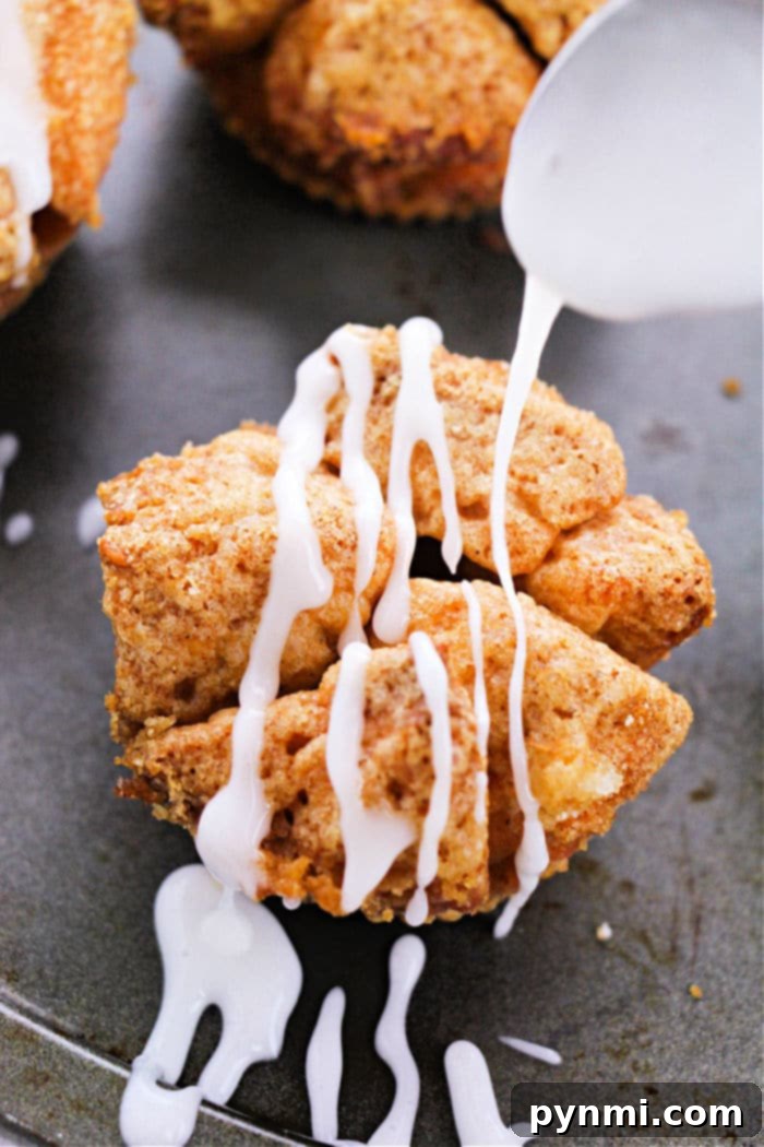Pull-Apart Monkey Bread Muffins 9 A close-up of a single monkey bread muffin, golden and sticky, with visible glaze.