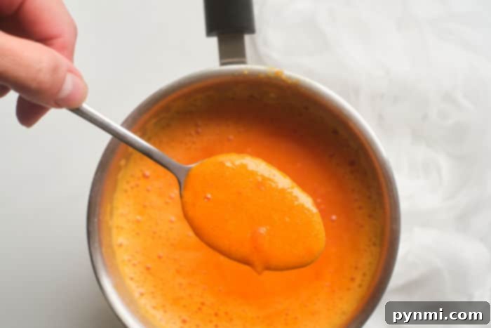 Hot wings sauce being prepared in a saucepan