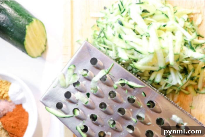 Freshly grated zucchini, ready for baking, showcasing its vibrant green skin.