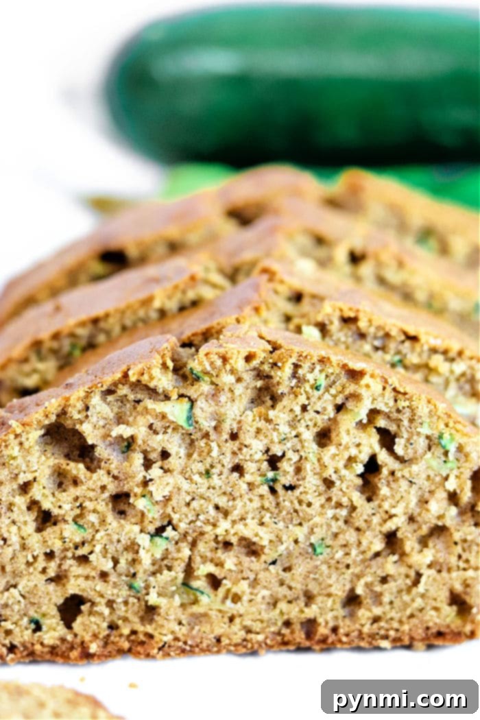 A slice of Zucchini Gingerbread, showcasing its moist crumb and rich color.