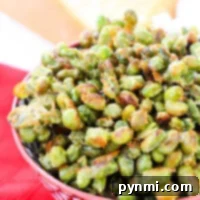 A bowl of dried edamame sits invitingly on a red patterned tablecloth, offering a tasty and nutritious snack.