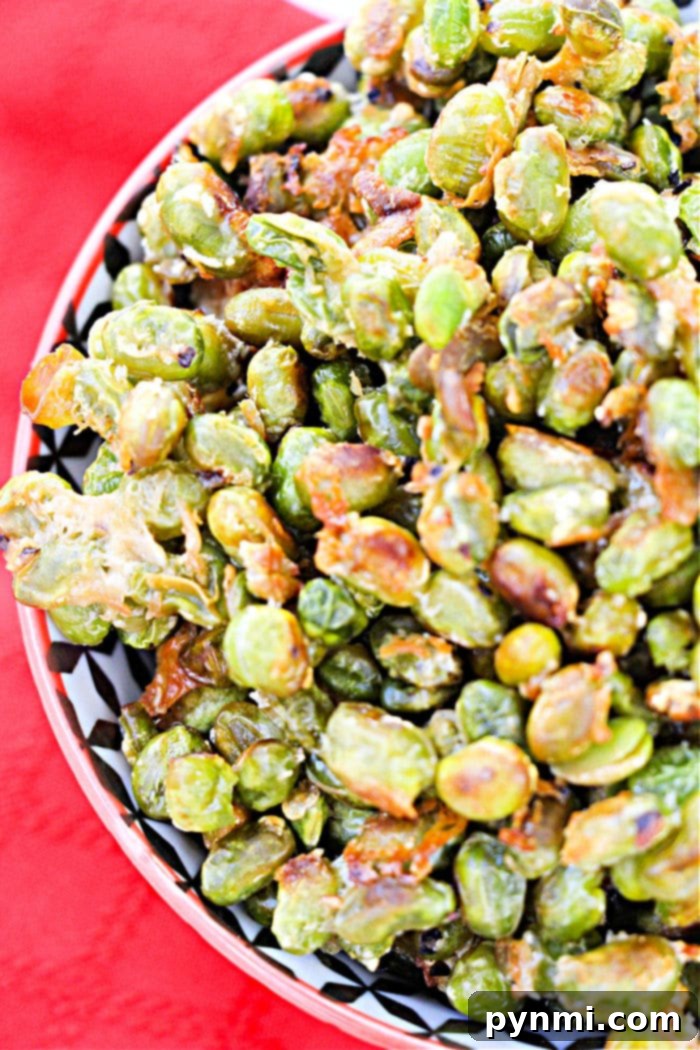 Crispy Roasted Edamame 7 A vibrant bowl of oven-roasted edamame, perfectly seasoned and ready for snacking. The focus is on the inviting texture and color.