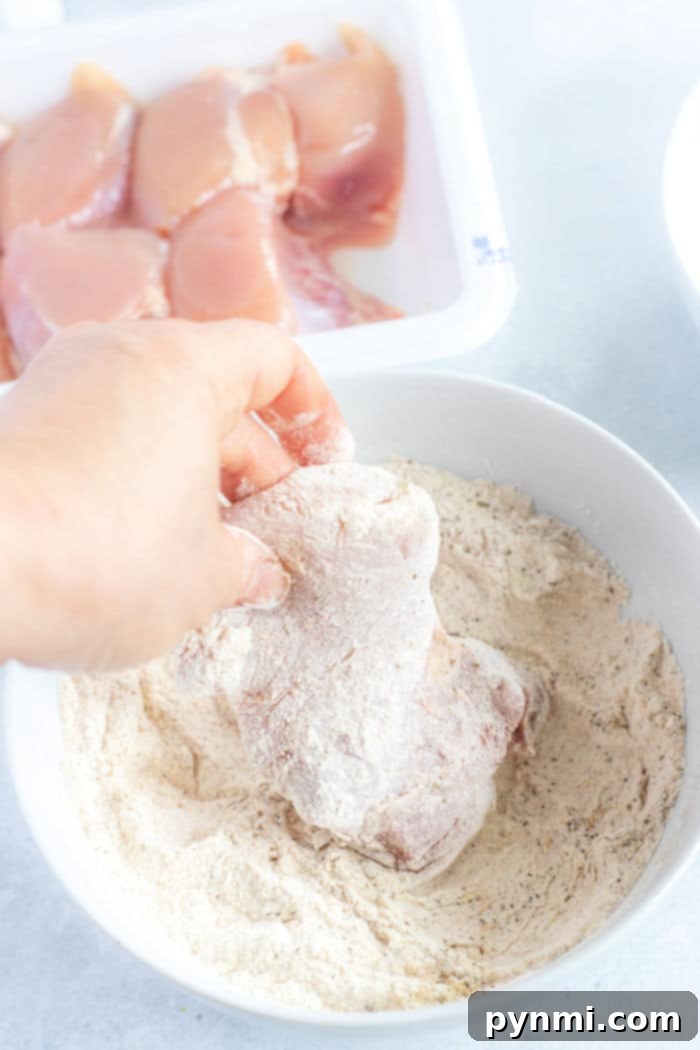 A close-up of crispy, golden-brown fried chicken thighs fresh from the air fryer, promising a delicious and healthier meal option.