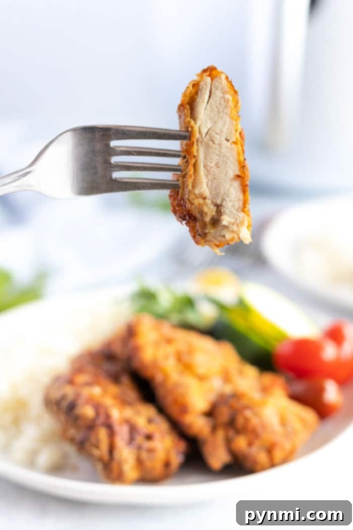 A beautifully arranged plate of Air Fryer Fried Chicken Thighs, garnished and ready to be served, highlighting their crispy texture and golden color.