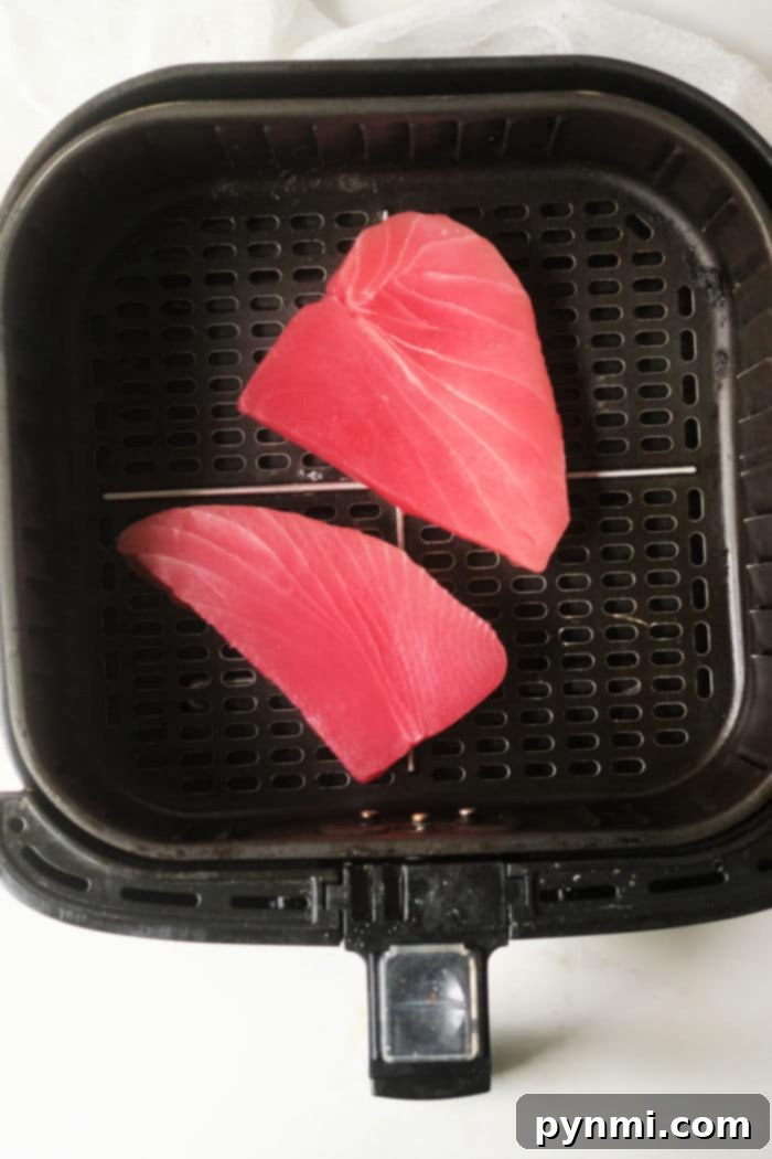 Close-up of a perfectly cooked air fryer tuna steak with a beautiful pink interior.