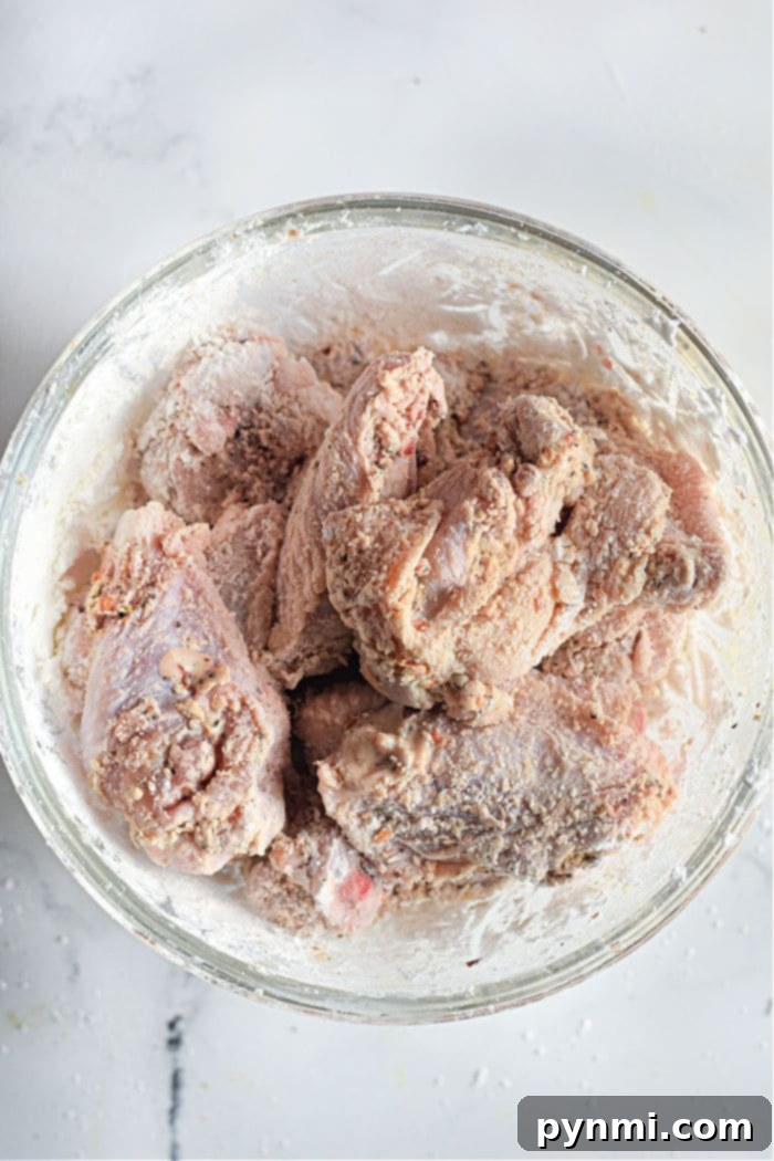 Raw firecracker chicken wings, coated in flour, are perfect for turning into air fryer delights.