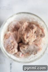 Raw firecracker chicken wings, coated in flour, are perfect for turning into air fryer delights.