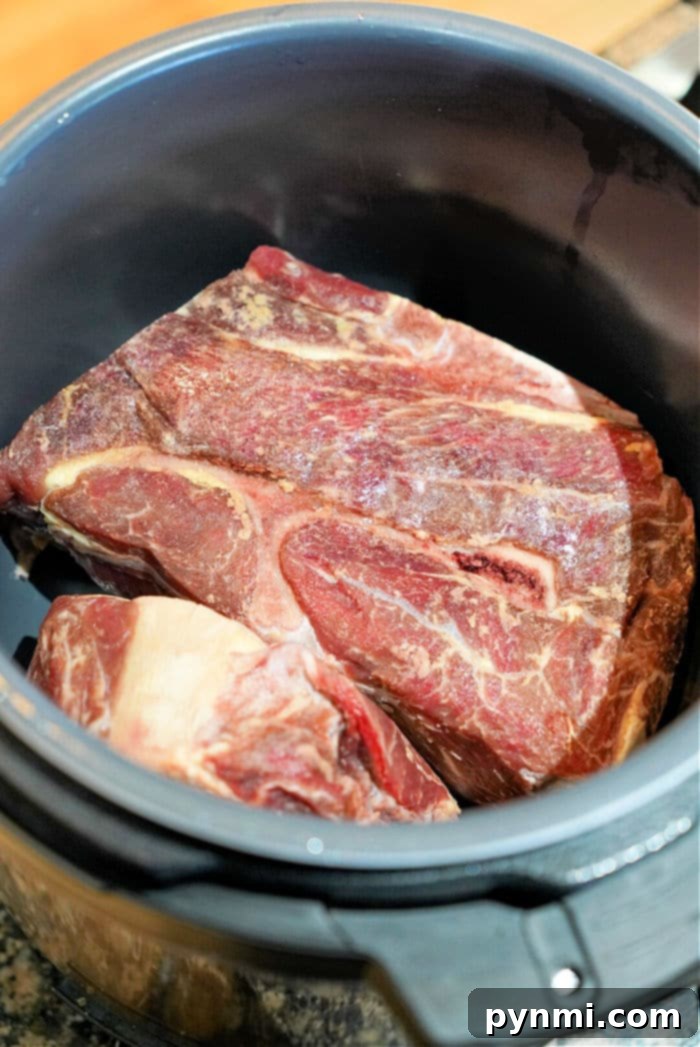 Effortless Instant Pot Frozen Chuck Roast 8 Instant Pot chuck roast, perfectly shredded and ready to be served over rice or in tacos.