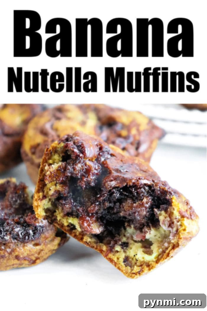 Nutella Swirl Banana Muffins 7 A stack of freshly baked Banana Nutella Muffins, golden brown with visible chocolate swirls, ready to be enjoyed.