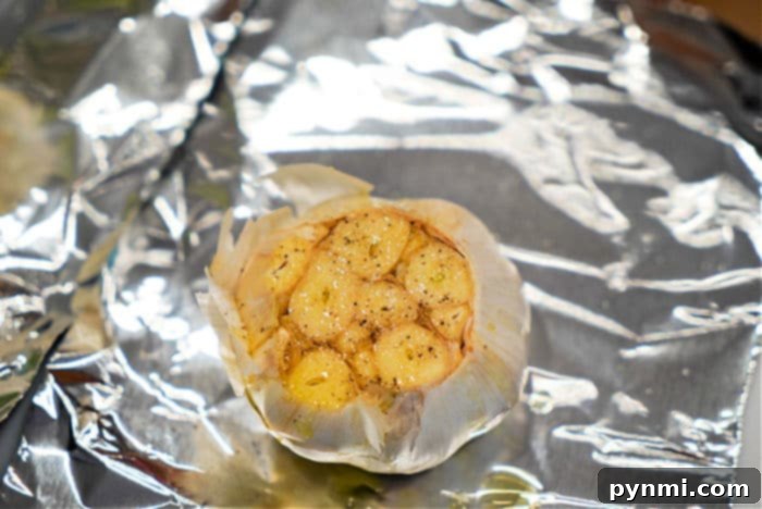 Tender, roasted garlic cloves unwrapped from foil after cooking in the air fryer.