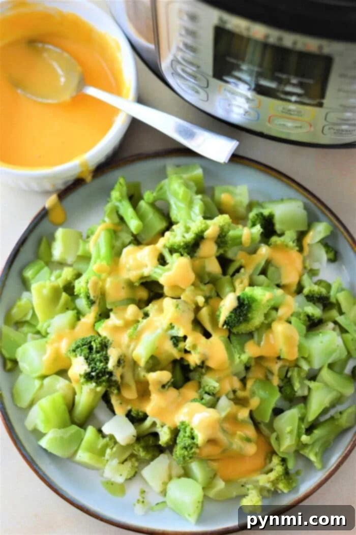 Perfectly steamed frozen broccoli in an Instant Pot, ready to serve with optional cheese sauce.