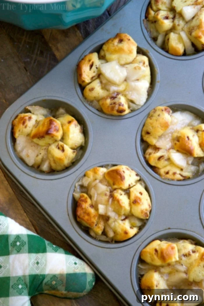 Sweet and easy apple pie monkey bread muffins, a favorite muffin tin recipe. Apple pie monkey bread muffins in a muffin tin