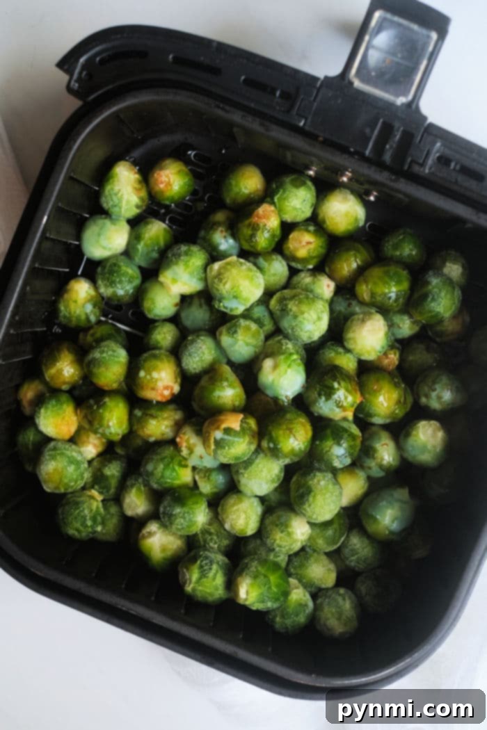 Crispy Air Fryer Frozen Brussels Sprouts 3 Frozen Brussels sprouts transforming into a crispy air fryer delight.