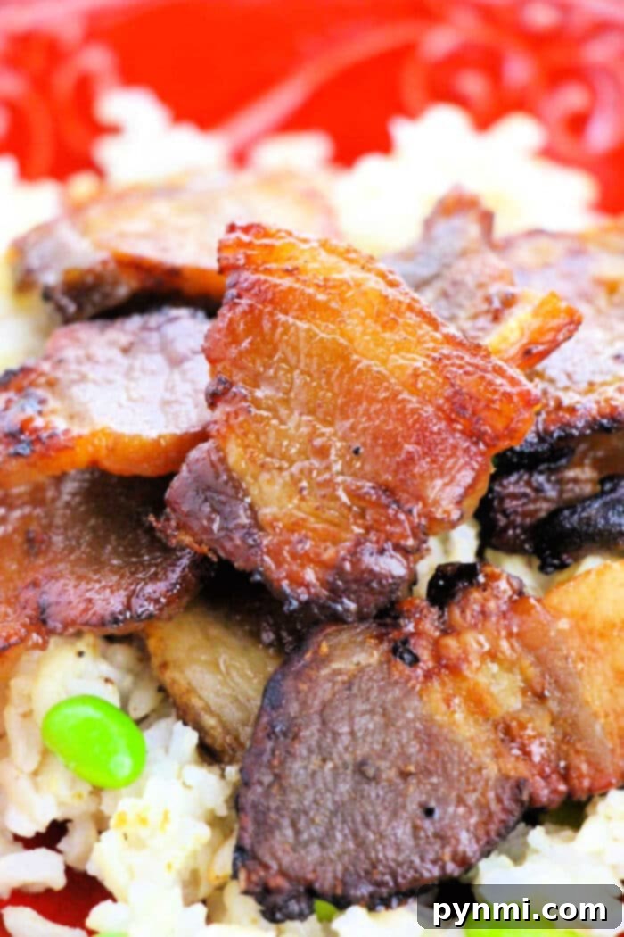 Crispy Oven-Roasted Pork Belly Perfection 2 Crispy oven-baked pork belly slices arranged on a baking sheet, ready to be served for a delicious meal.