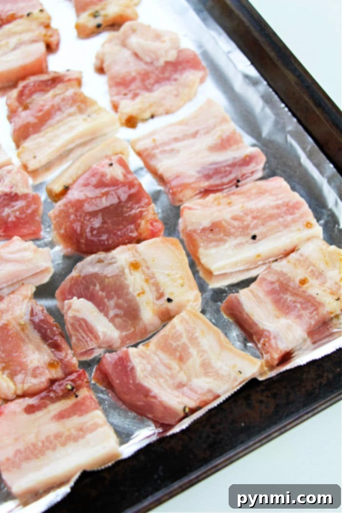 Crispy Oven-Roasted Pork Belly Perfection 5 Pork belly perfection is achieved by arranging slices of pork belly in the oven.
