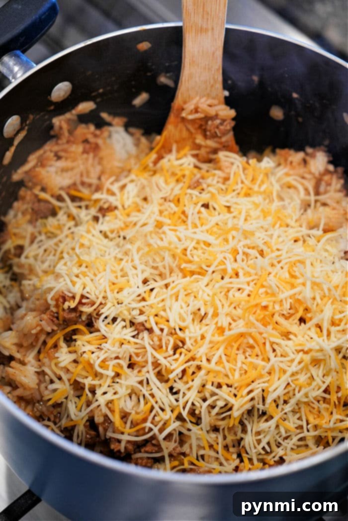Overhead view of a hearty ground beef and rice casserole in a white baking dish, ready to be served.