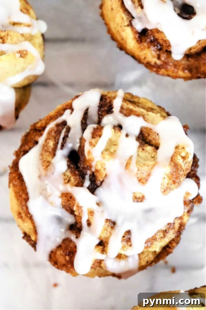 Sweet Cinnamon Swirl Muffins 8 Close-up of three no yeast cinnamon rolls muffins, perfectly swirled and ready to eat.