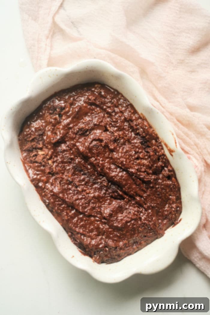 Spiced Chocolate Gingerbread Delight 5 A festive gingerbread cake with chocolate chips and powdered sugar, decorated for the holidays