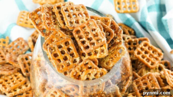 pretzels being coated with honey mustard seasoning