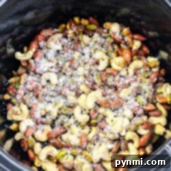 In a slow cooker, create a delightful Cheese It Snack Mix by blending mixed nuts with grated cheese and your favorite seasonings.
