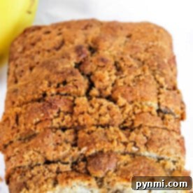 Close-up of a loaf of banana bread with a crumbly, golden-brown crust, made effortlessly using a Bisquick banana bread recipe.