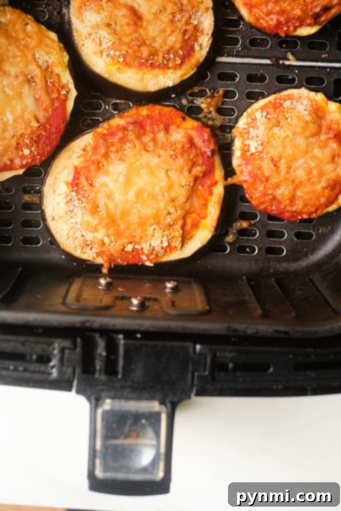 Crispy Air Fried Eggplant Parmesan No Breading 7 Air fryer eggplant parm with cheese and tomato sauce cooked to perfection in an air fryer basket