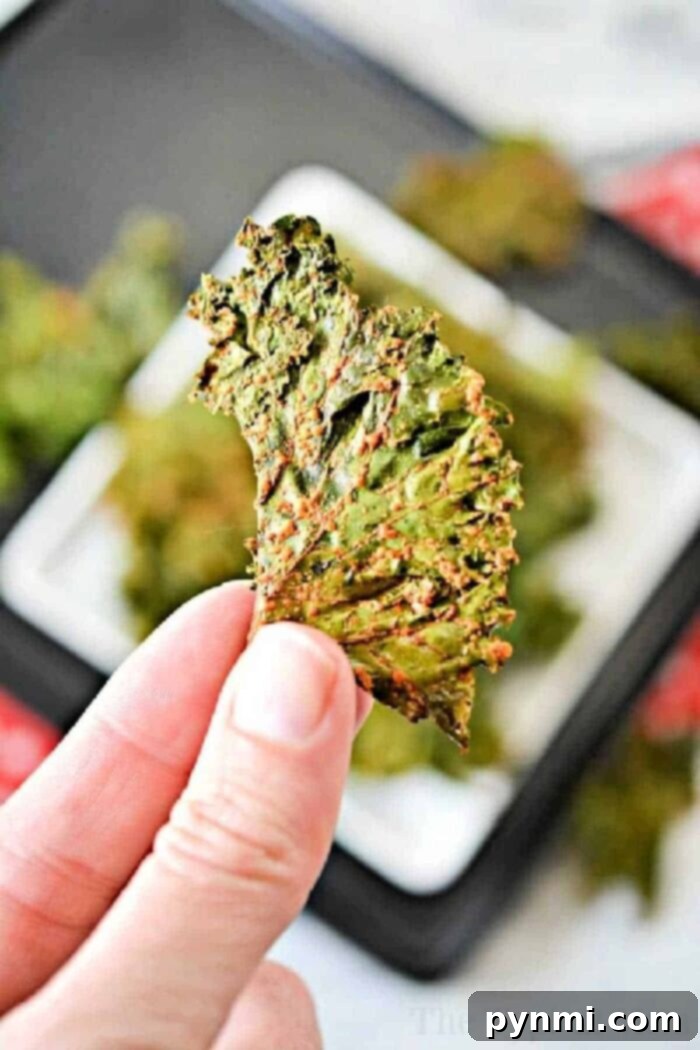 How to Make Kale Chips in the Oven - A beautifully arranged tray of golden, crispy kale chips fresh from the oven, ready to be enjoyed as a healthy snack.