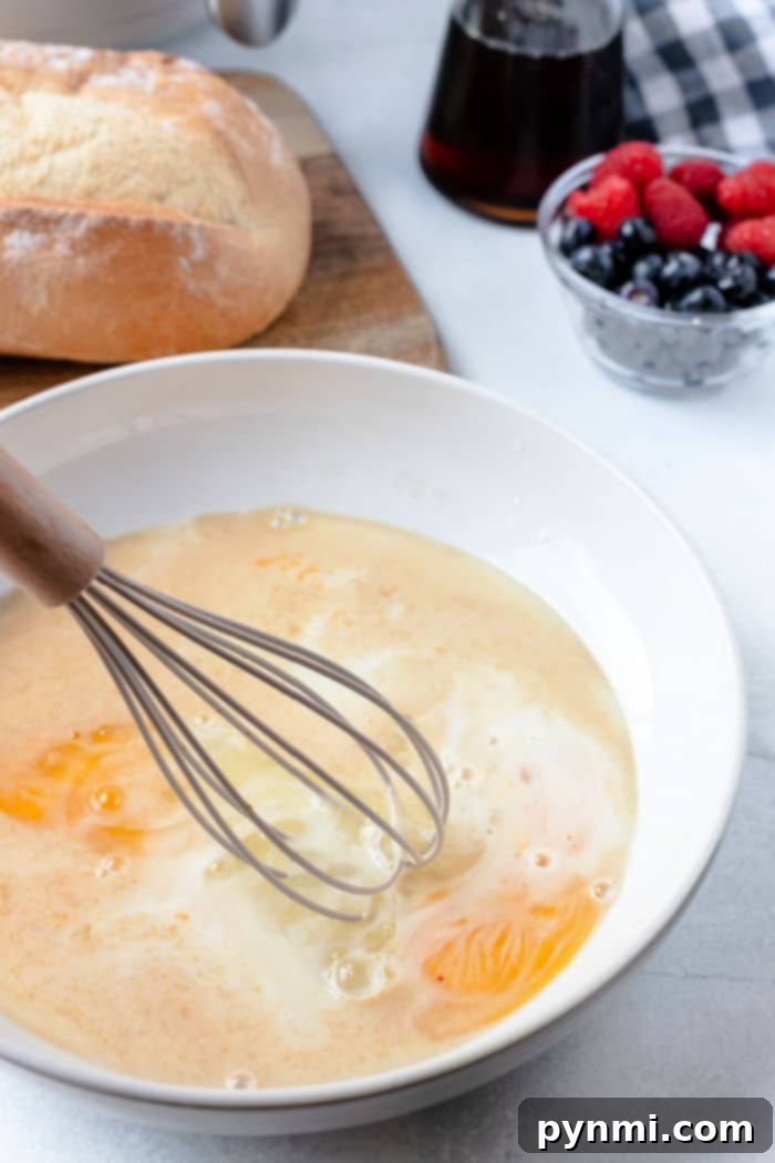 The process of dipping thick-sliced bread into an egg and milk mixture for homemade French toast.