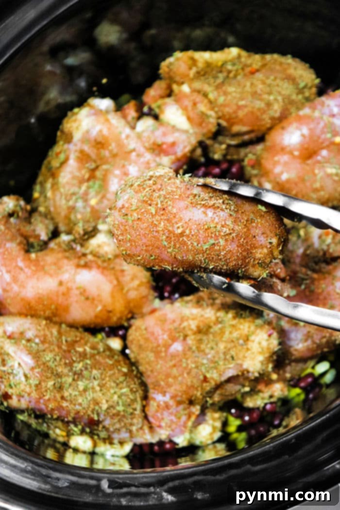 A top-down view of slow cooker jerk chicken, glistening with sauce and tender.