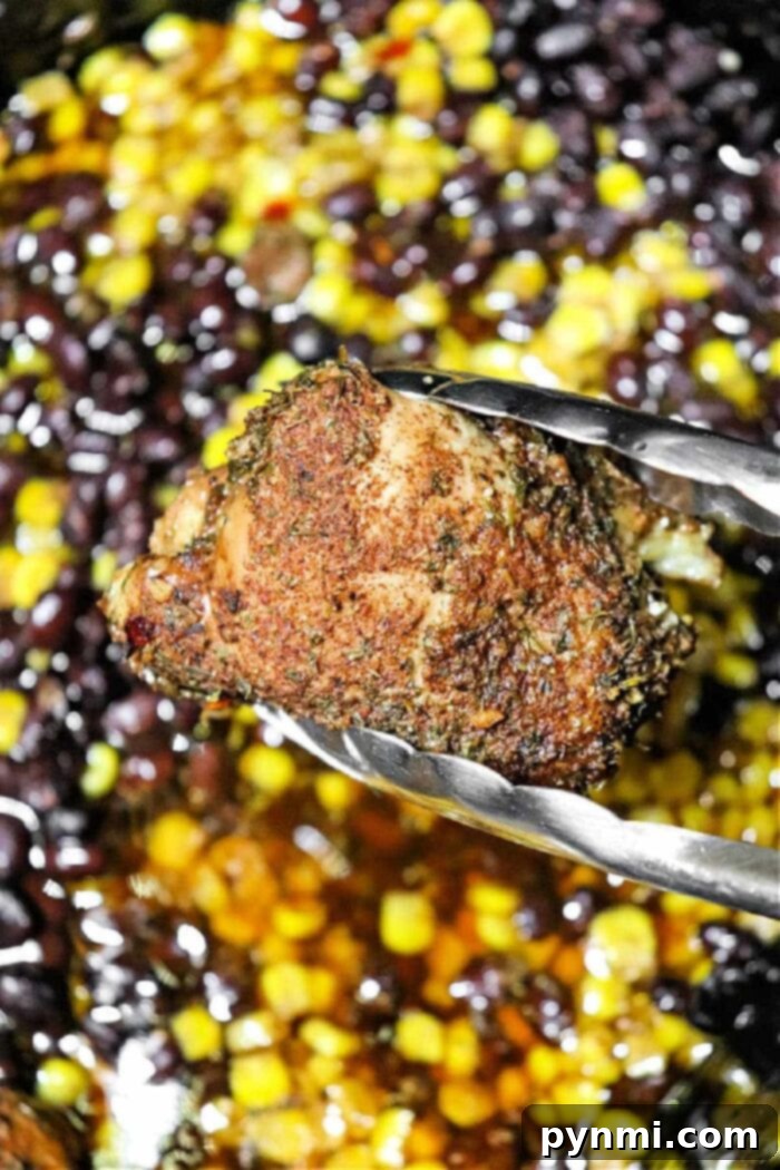 A close-up of tender Crockpot Jerk Chicken Thighs, showcasing the rich seasoning and texture.