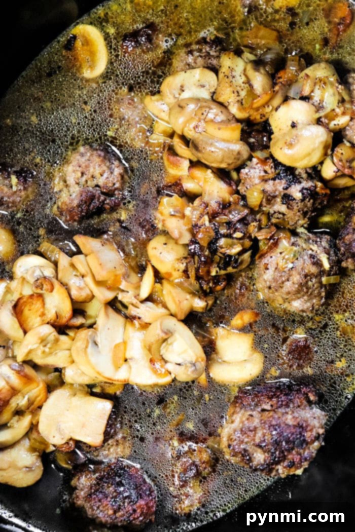 Crockpot Meatballs recipe simmering in a slow cooker.