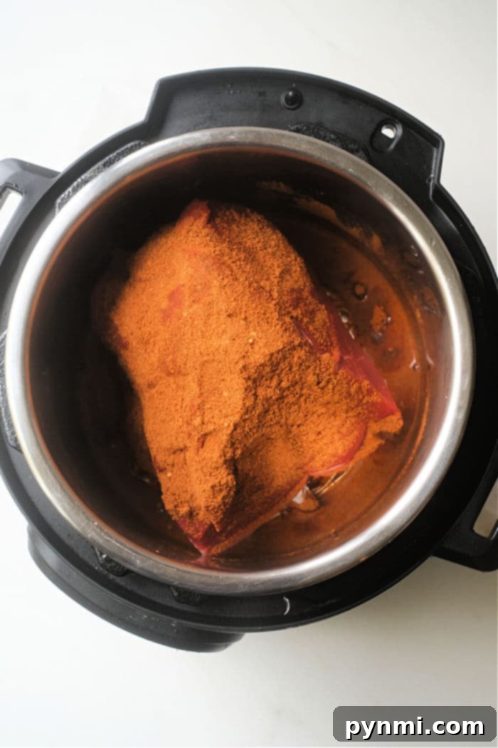 Tender Instant Pot Mexican Pot Roast, perfectly seasoned and ready for slicing.