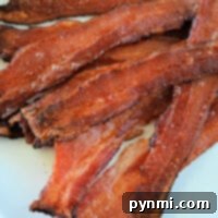 A plate of crispy bacon strips, prepared from frozen, shows the satisfying result of mastering how to cook frozen bacon perfectly.