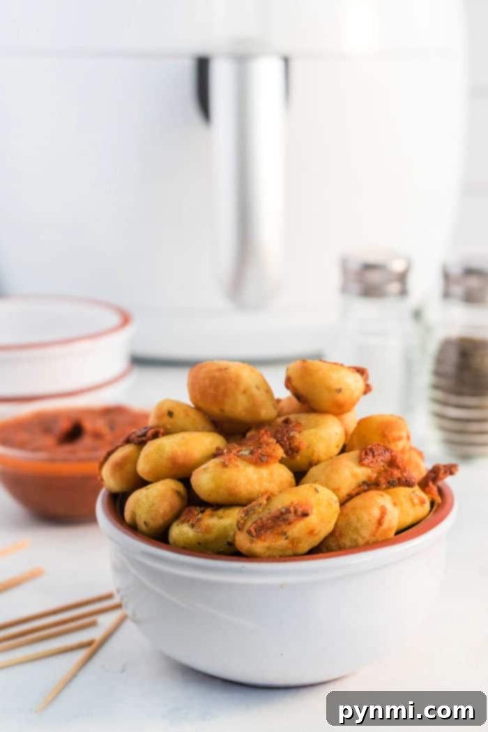 A final shot of air fryer gnocchi, perfectly golden and crispy, on a plate ready for serving.
