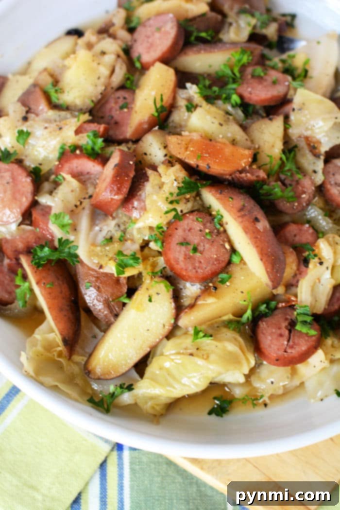 Comforting Crockpot Cabbage Creations 4 Hearty slow cooker cabbage and sausage dish, featuring tender cabbage, savory sausage, and potatoes.