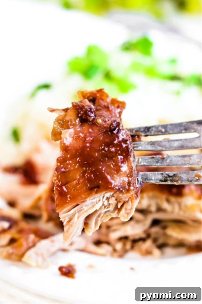 Crockpot BBQ Chicken Thighs, perfectly cooked and coated in a rich, tangy sauce, ready to be served.