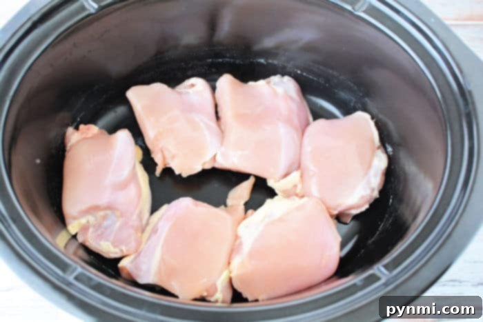 Effortless Slow Cooker Chicken Thighs and Potatoes 4 Slow Cooker Chicken with golden-brown skin, cooked to perfection, showcasing a delicious and tender result.